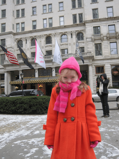 new york city-girl outside plaza hotel-winter
