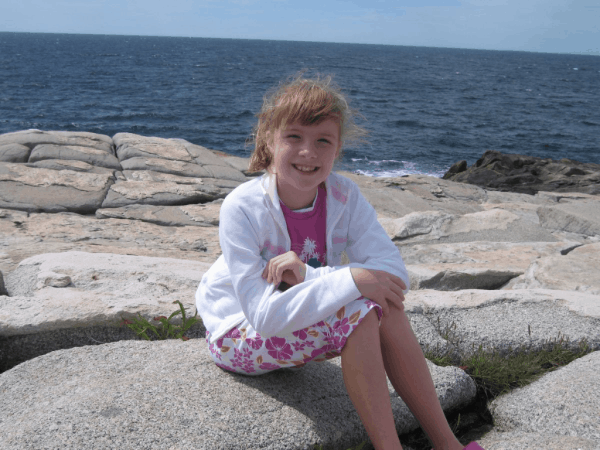 nova scotia-peggy's cove-girl sitting on rocks