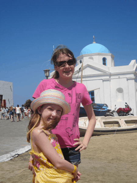 Greece-young girls on Mykonos - church in background