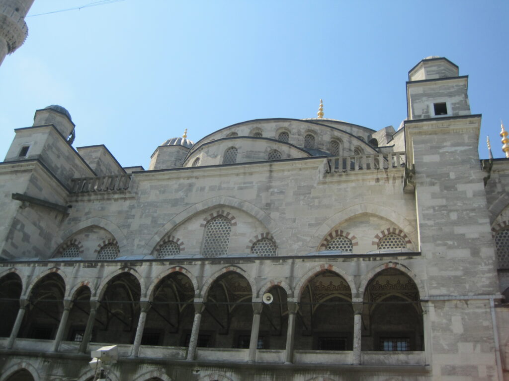 Exterior of the Blue Mosque set against bright blue sky - Istanbul, Turkey.