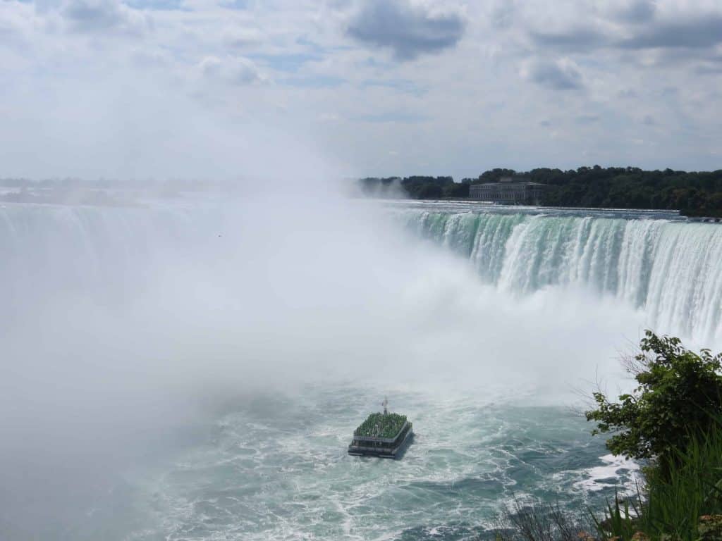 Hornblower Cruises boat sailing into the basin of Horseshoe Falls, Niagara Falls, Canada.