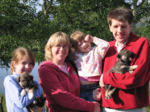 Family with sled dog puppies in Alaska