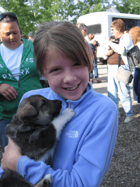 Holding a puppy at Husky Homestead in Alaska