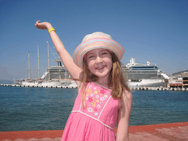 Turkey-Kusadasi-girl posing in front of Celebrity Equinox