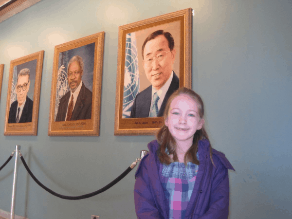 New York City-UN Headquarters-girl with portraits of Secretaries General of the UN