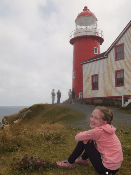 Newfoundland-Ferryland Lighthouse-girl sitting outside