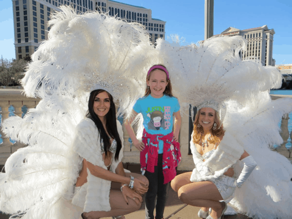 Posing with Vegas showgirls on Las Vegas Strip
