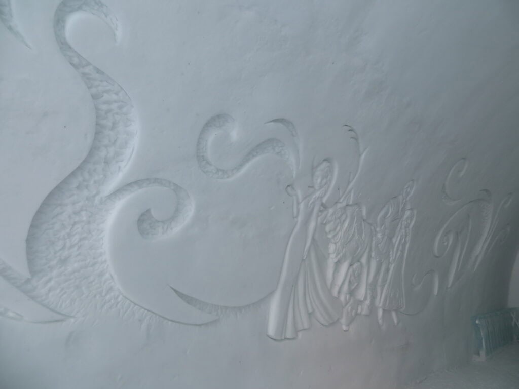 mural of scene from Disney's Frozen carved in snow wall.