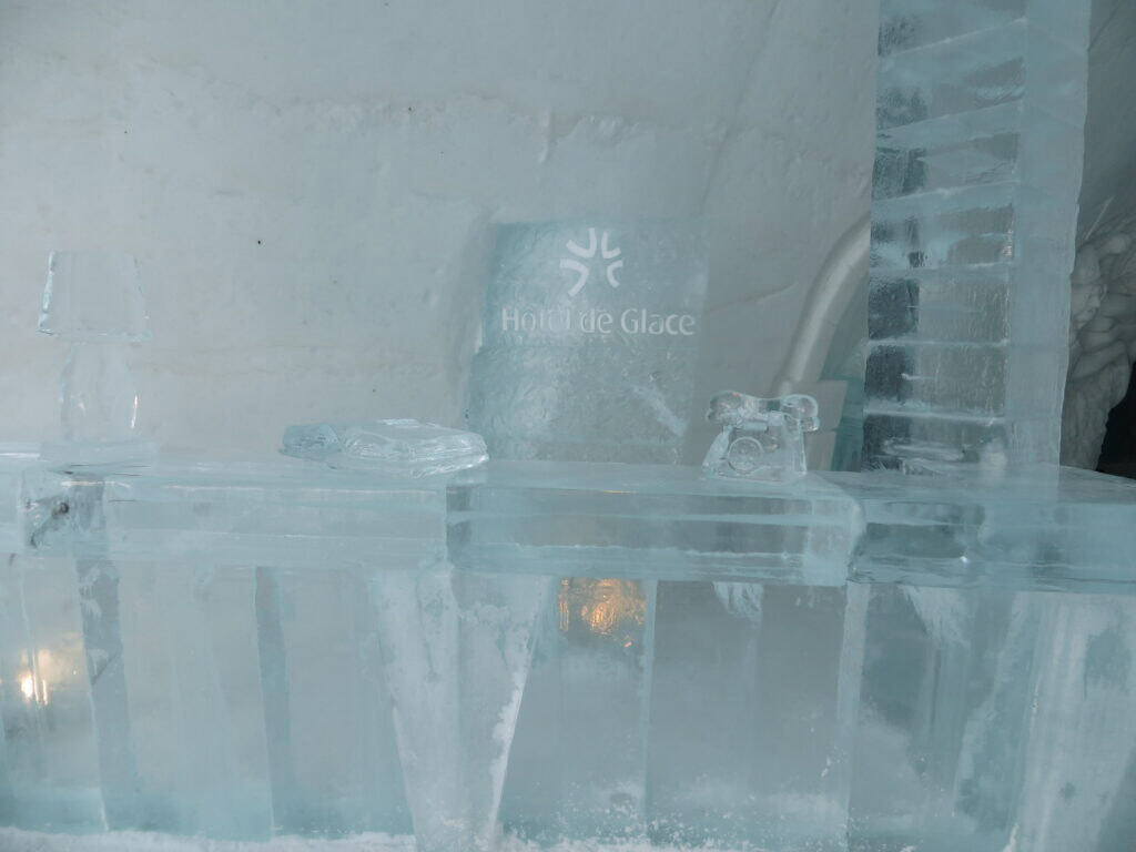 ice hotel reception desk made from ice with ice telephone.