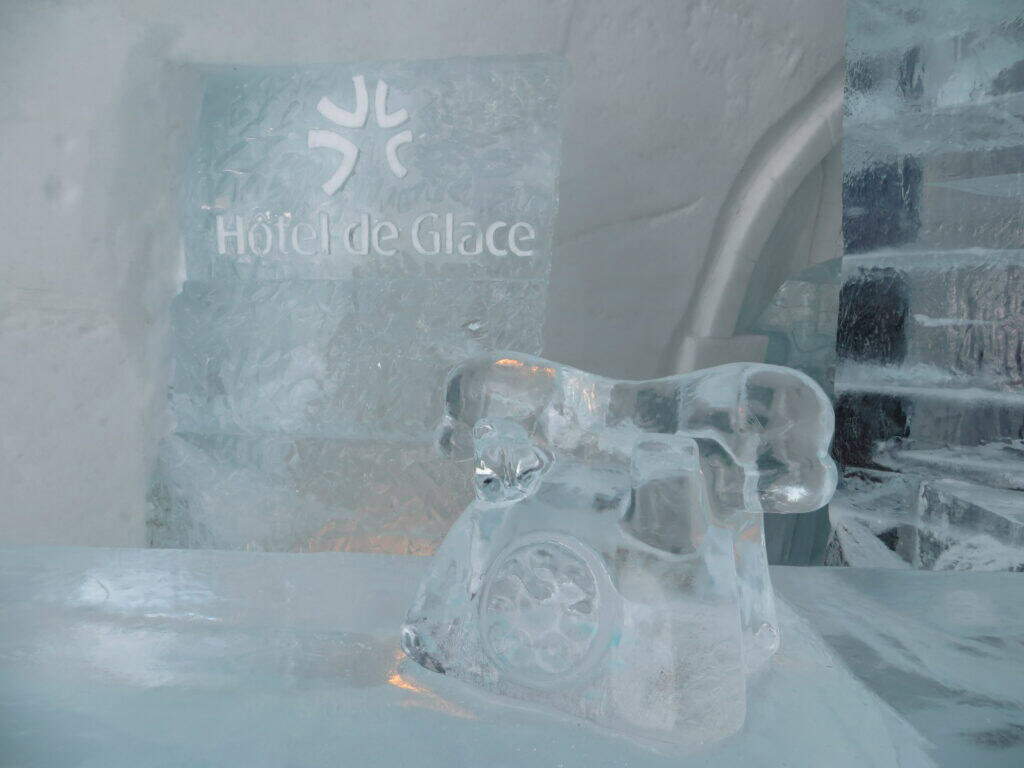 telephone made from ice sitting on reception desk made from ice - Quebec Ice Hotel.