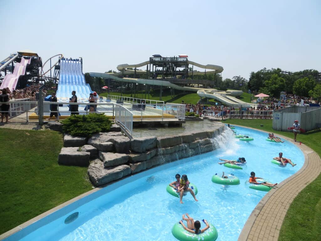People floating in green inner tubes in the lazy river at Canada's Wonderland.