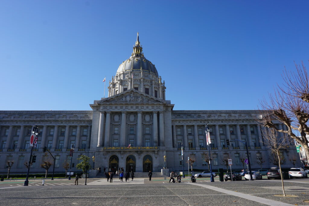 San Francisco City Hall against bright blue morning sky.
