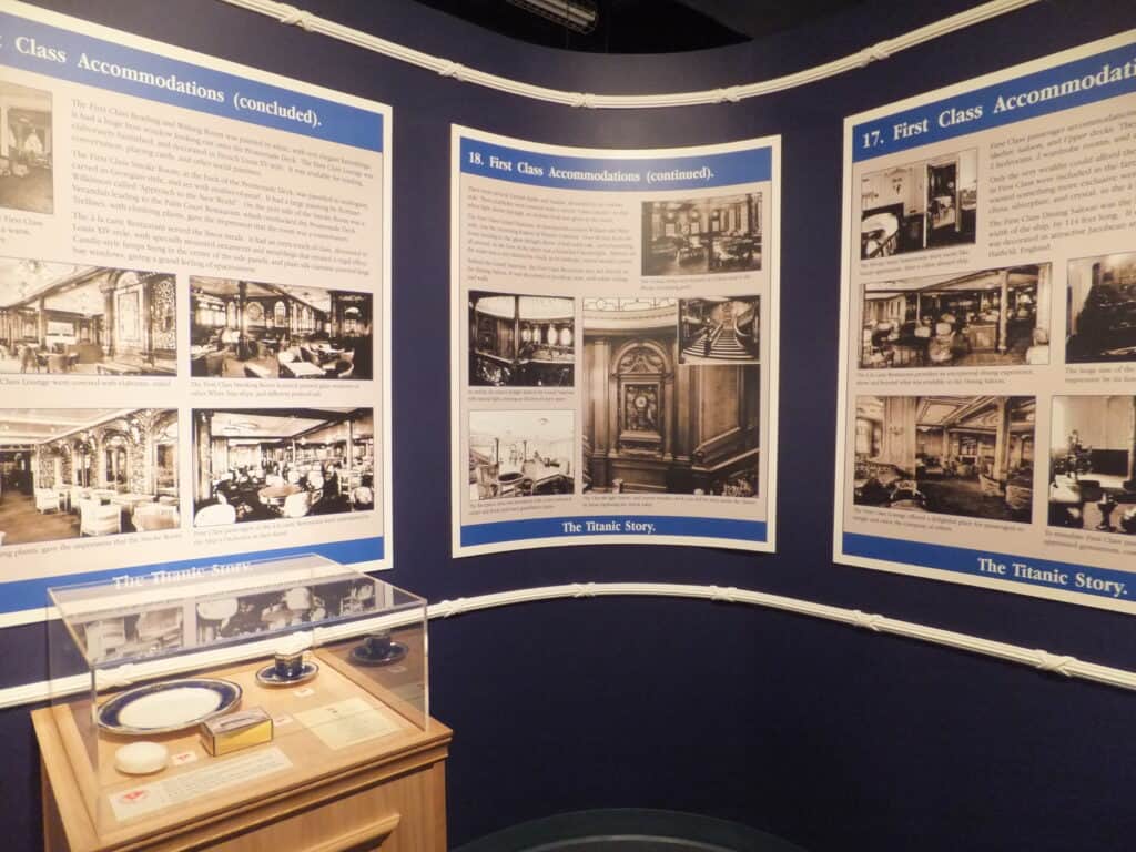 Photo and information panels and artifacts on display in a case as part of the Titanic Story exhibit at the Johnson GEO Centre in St. John's, Newfoundland.