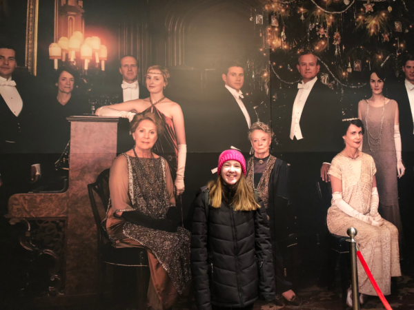 New york city-downton abbey exhibition-girl with portrait of Crawley family