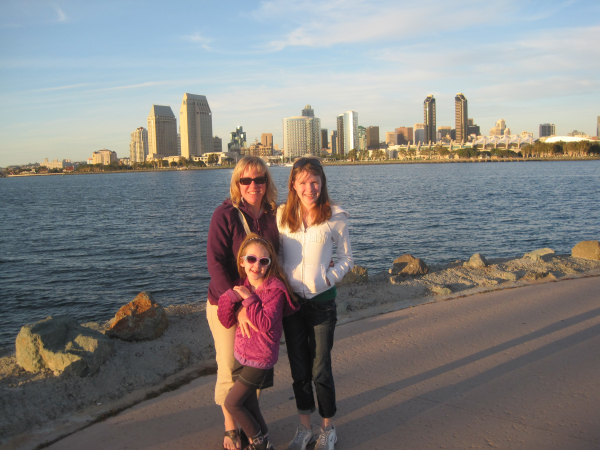 Mom and two daughters posing with view of San Diego skyline from Coronado Island