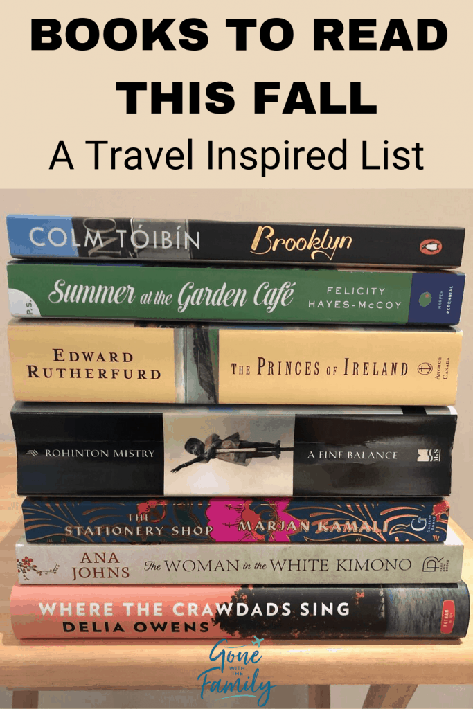 Stack of books on table with caption "books to read this fall - a travel inspired list"