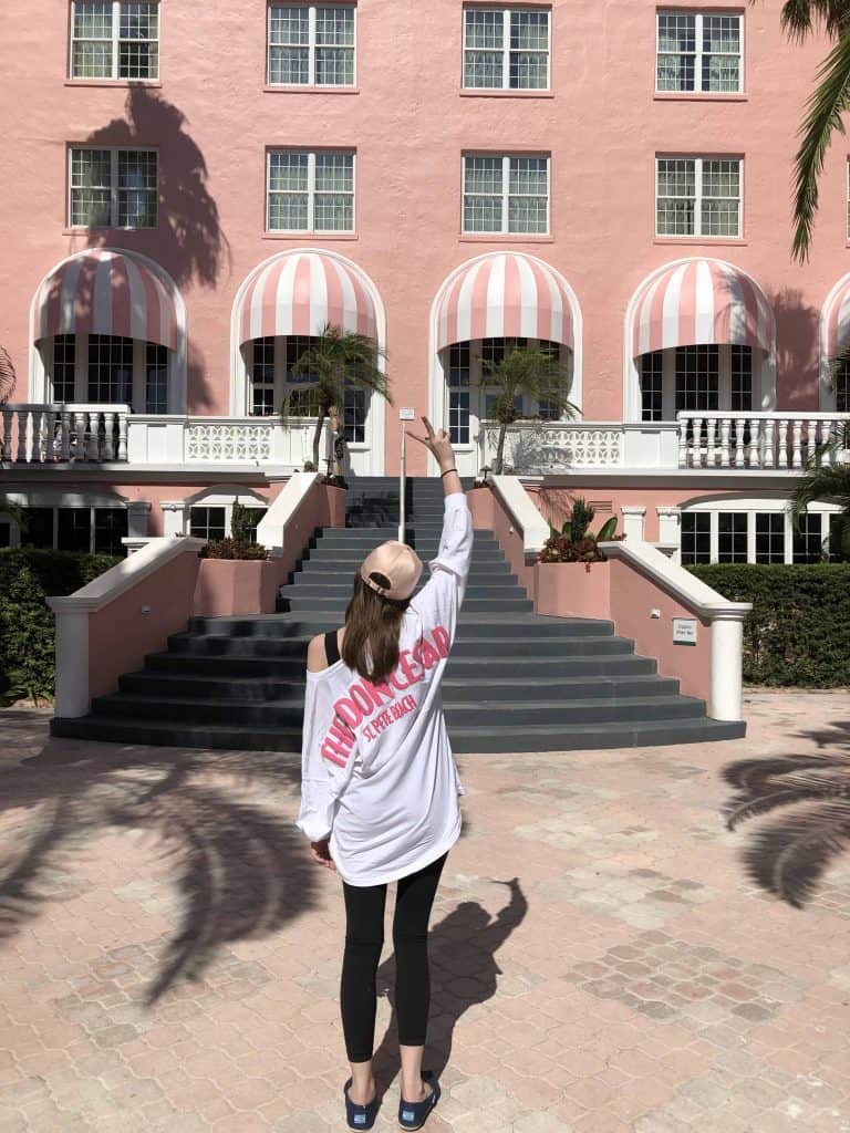 young woman at stairs rear of Don CeSar Hotel