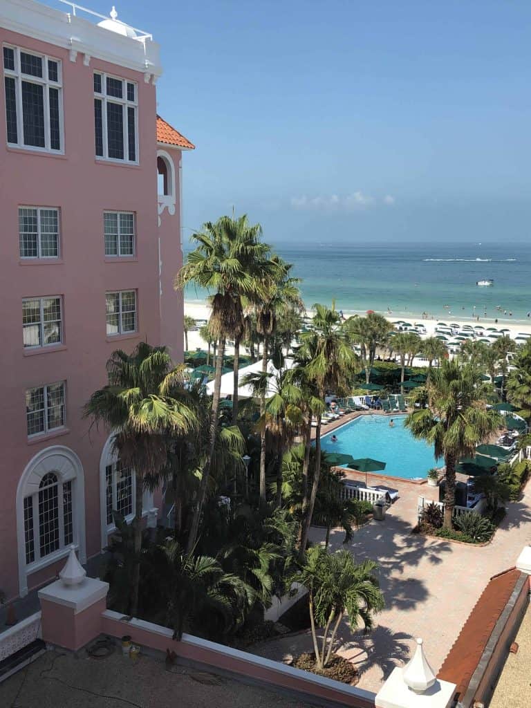 View of ocean and swimming pool from room at pink hotel