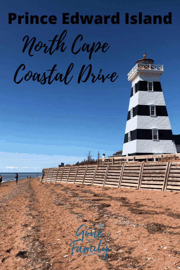 black and white striped lighthouse on beach