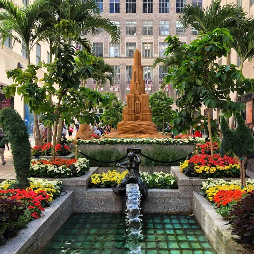 tropical garden with sand castle and water feature in city