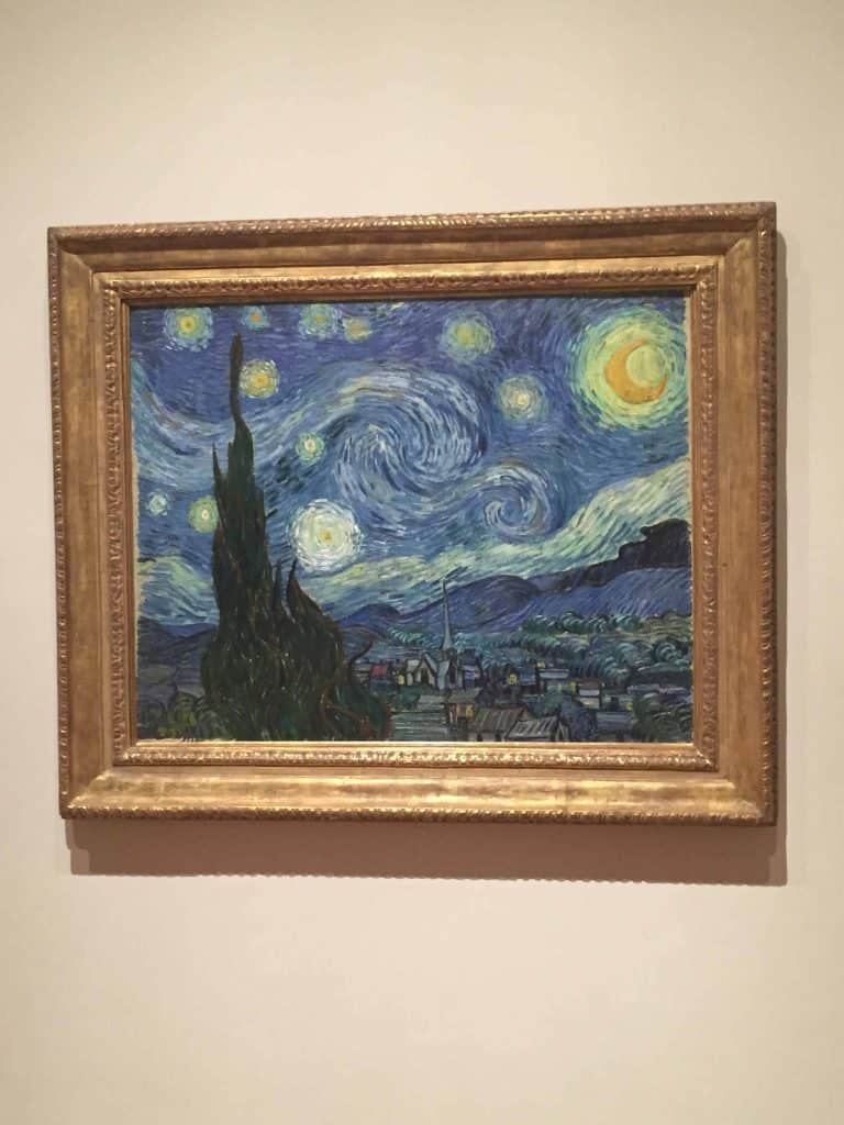 van gogh starry night painting hanging on wall