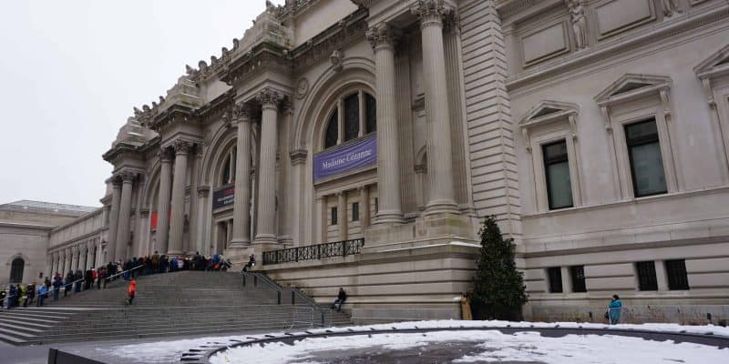 Exterior of the Metropolitan Museum in New York City in winter with patches of snow on the ground