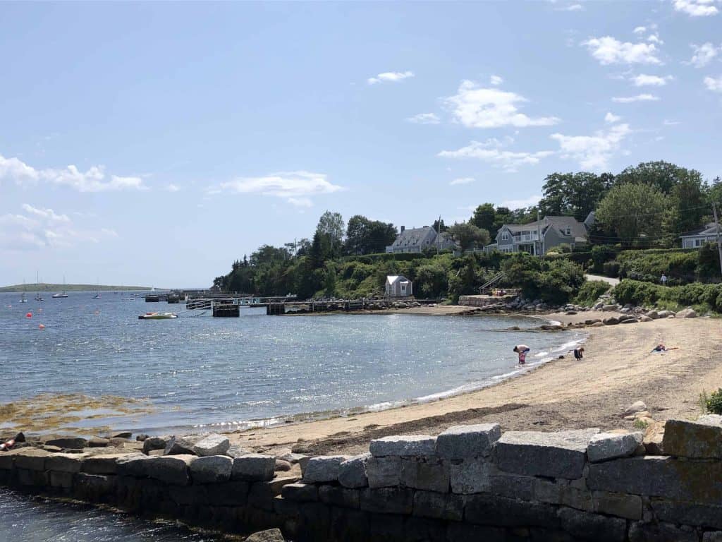 people on sand beach by ocean