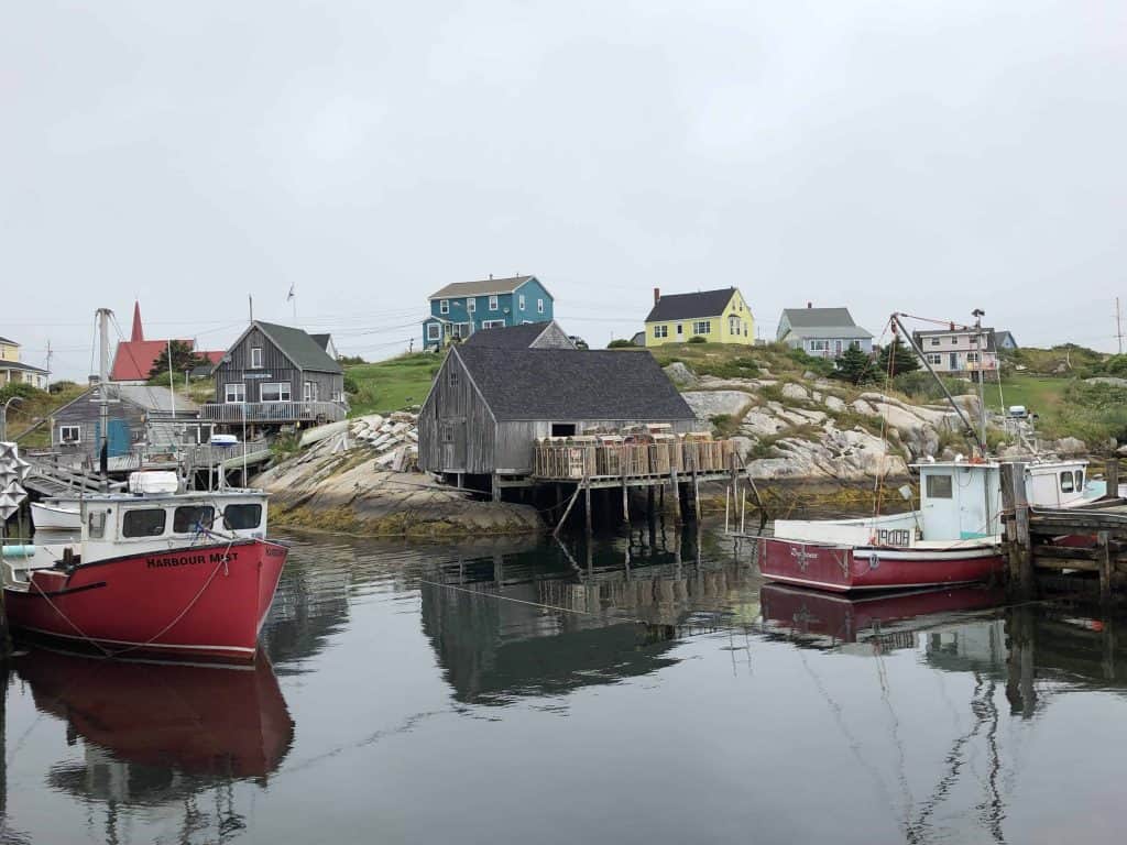 nova scotia lighthouse route-peggy's cove-red and white boats and colourful buildings on rocky shore