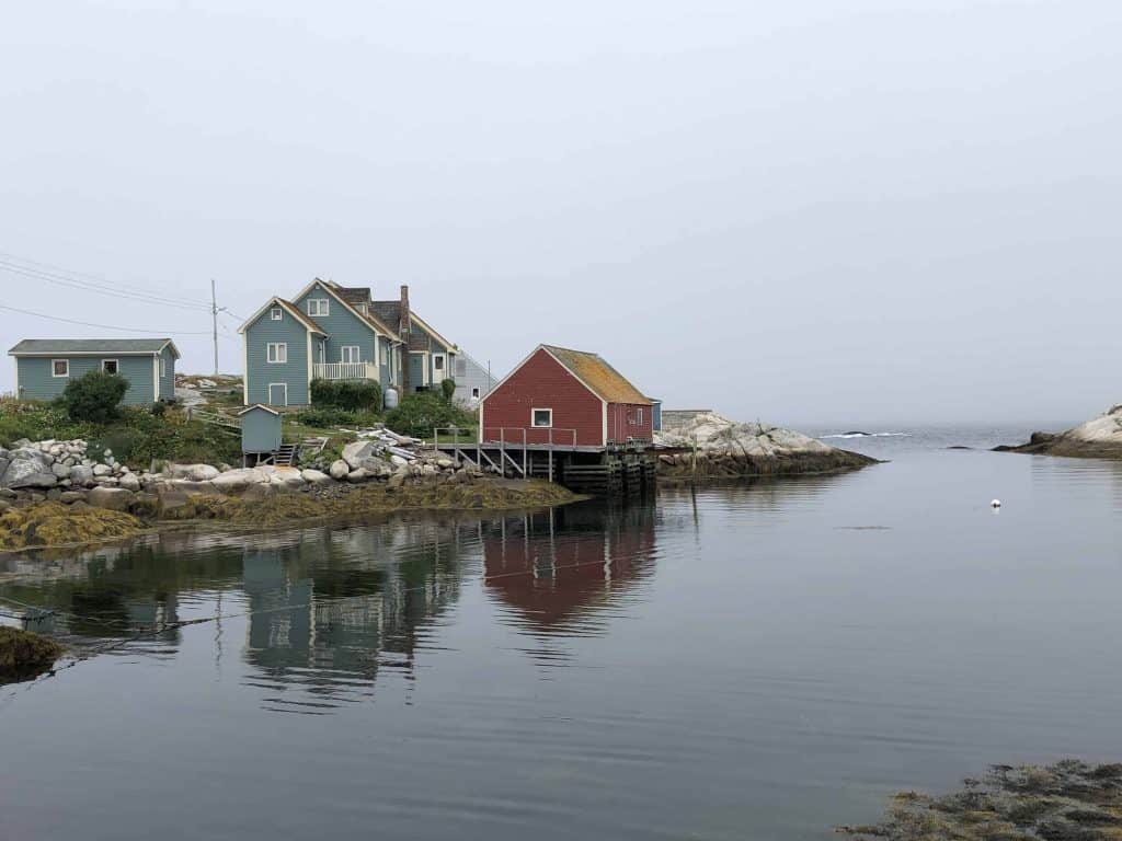 nova scotia lighthouse route-peggy's cove-colourful homes reflected in harbour