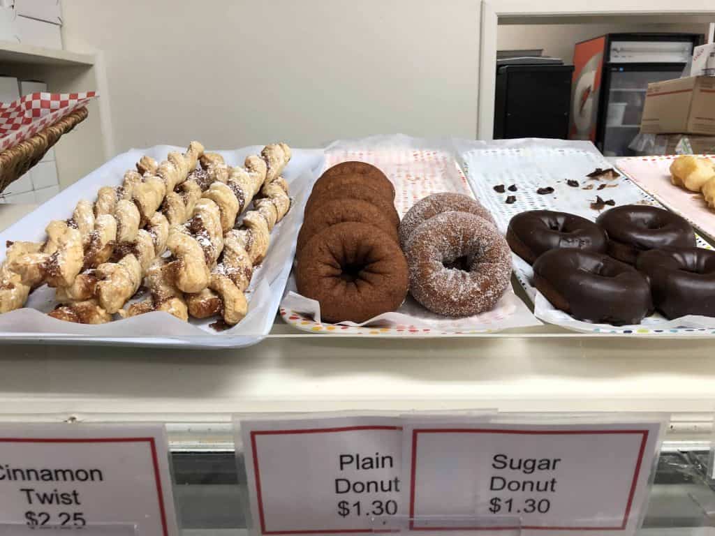 donuts and pastries on display in case