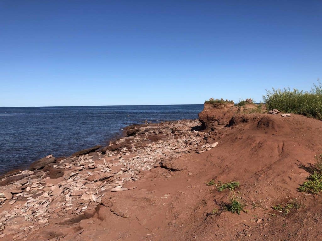 red sand and rocky beach - north cape prince edward island