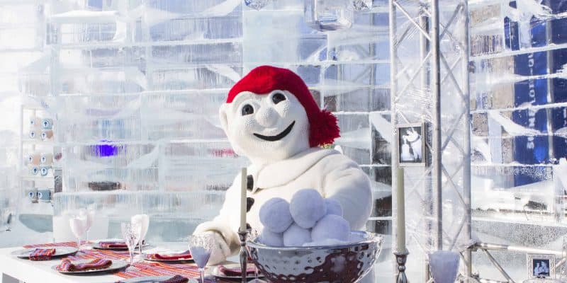 bonhomme snowman in red hat at dining table in ice castle