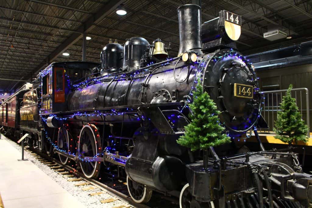 train in museum with christmas trees