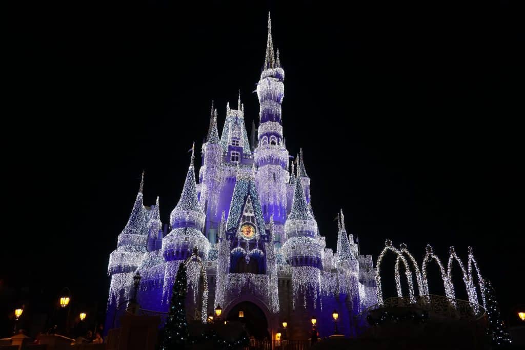 cinderella's castle at night covered with lights-disney world