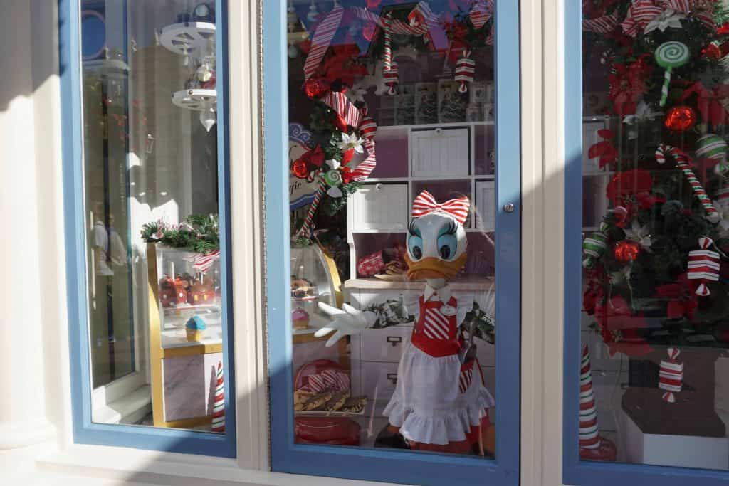disney shop window decorated for christmas with daisy duck