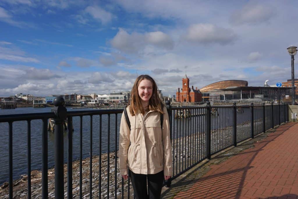 teen girl walking by waterfront in cardiff bay