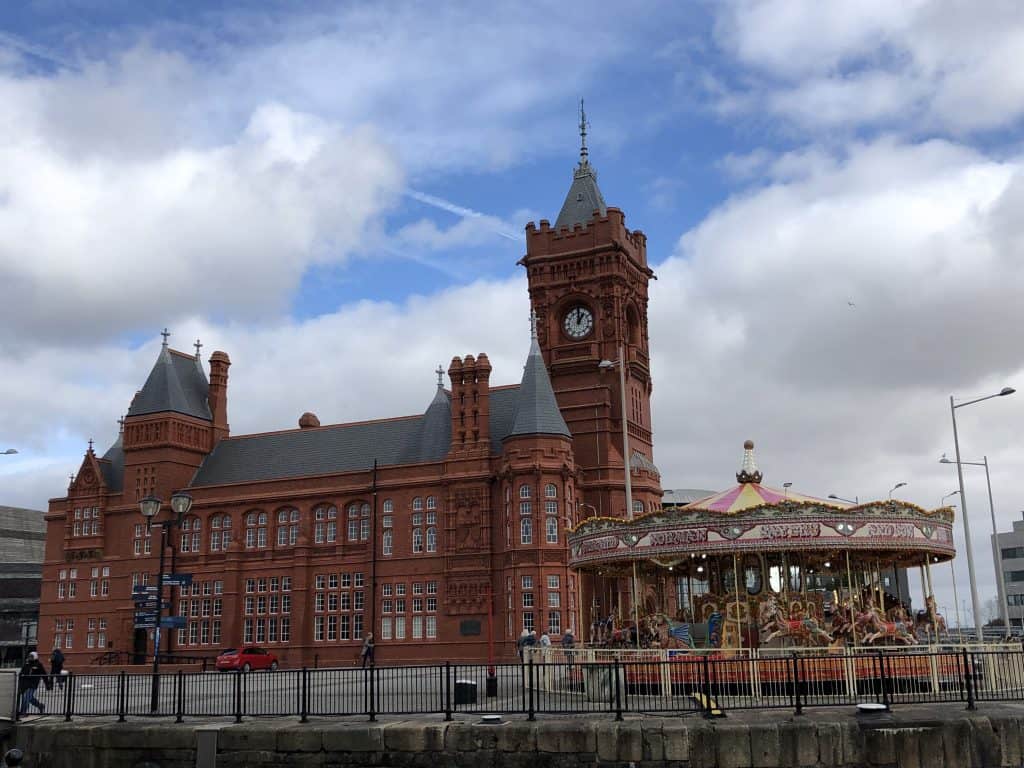 red stone building and carousel on pier