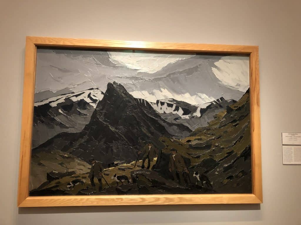 painting of men in mountains with dogs