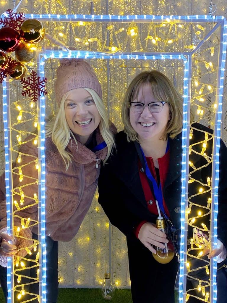 Two women standing in lights at Glow Toronto.