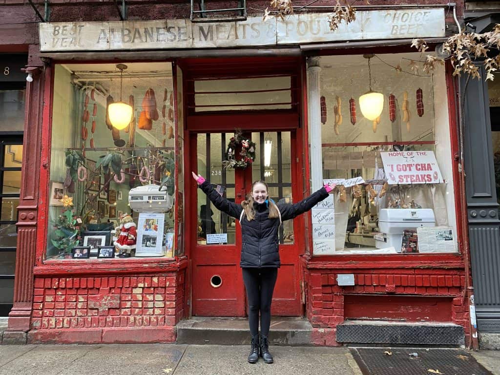 girl outside Albanese Meats & Poultry New York