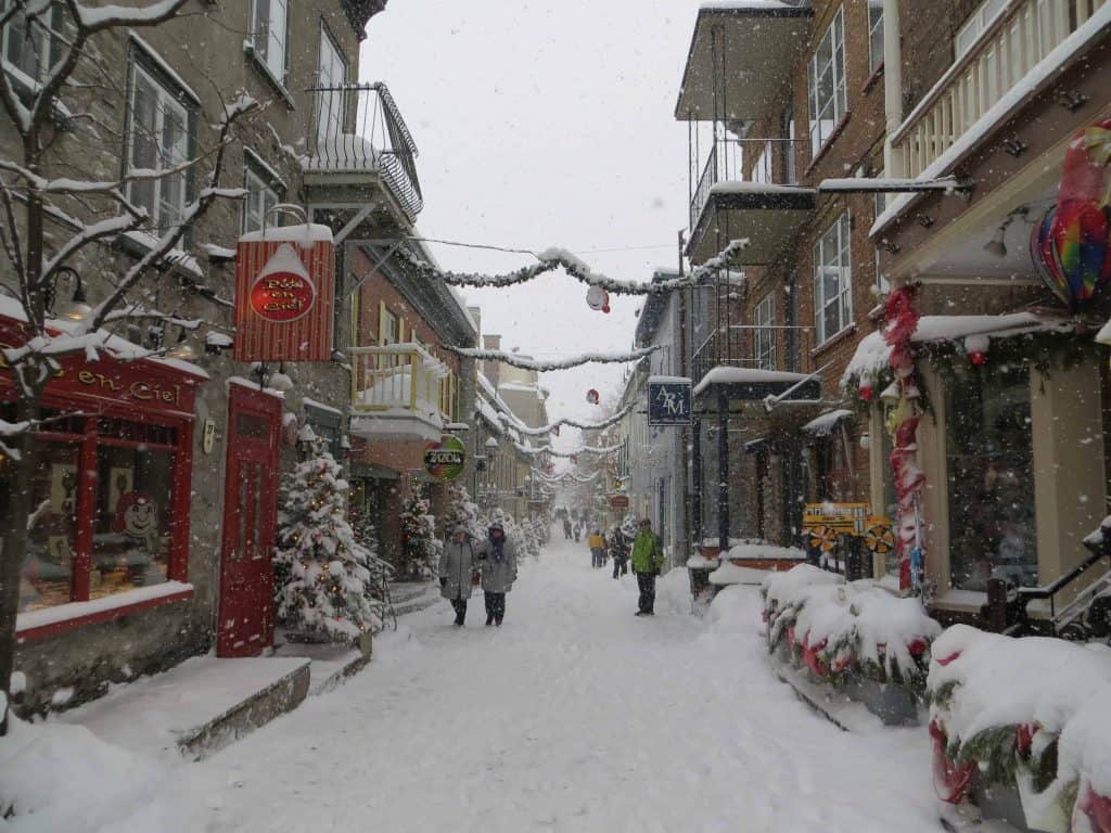 Rue petit champlain in Quebec City in winter with snow covered streets and a light snow falling.