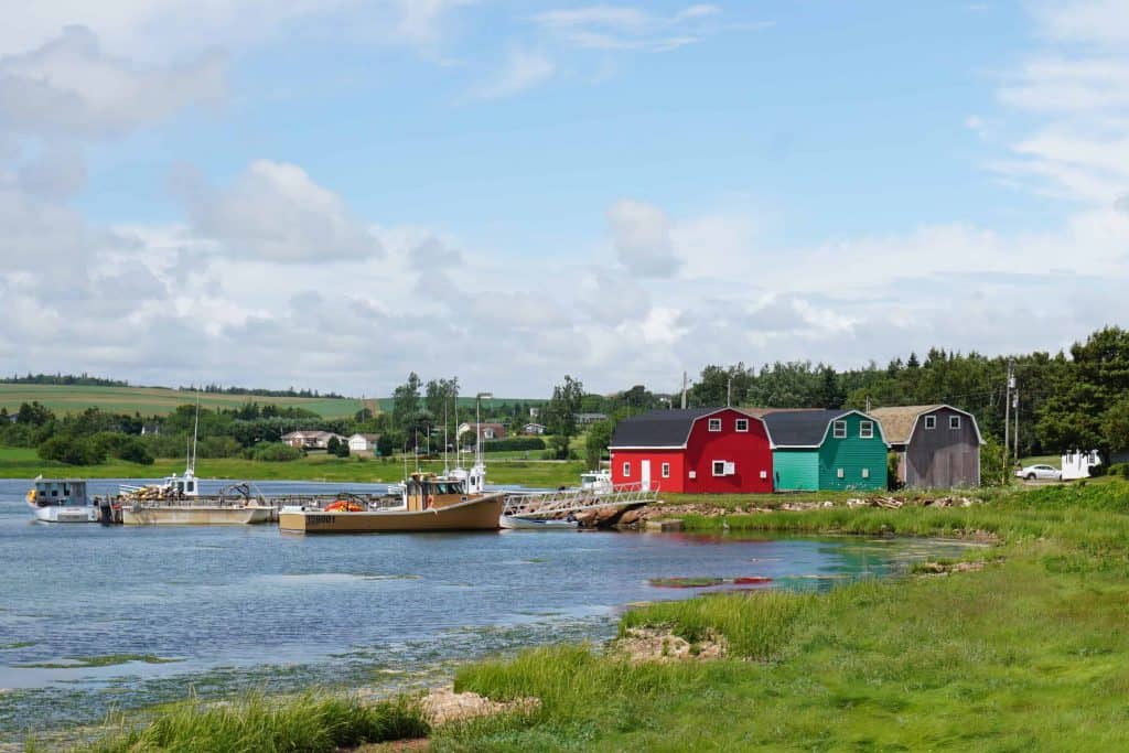 colourful buildings and boats on shoreline in French River, PEI.