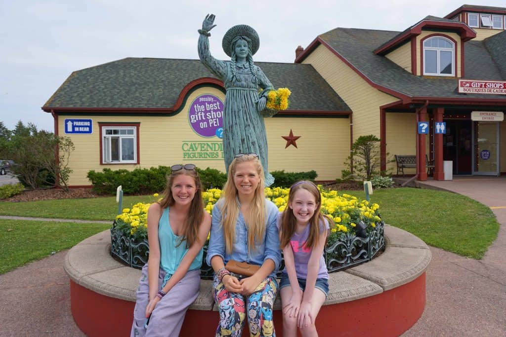 Girls with Spirit of Anne statue in Gateway Village, Prince Edward Island.