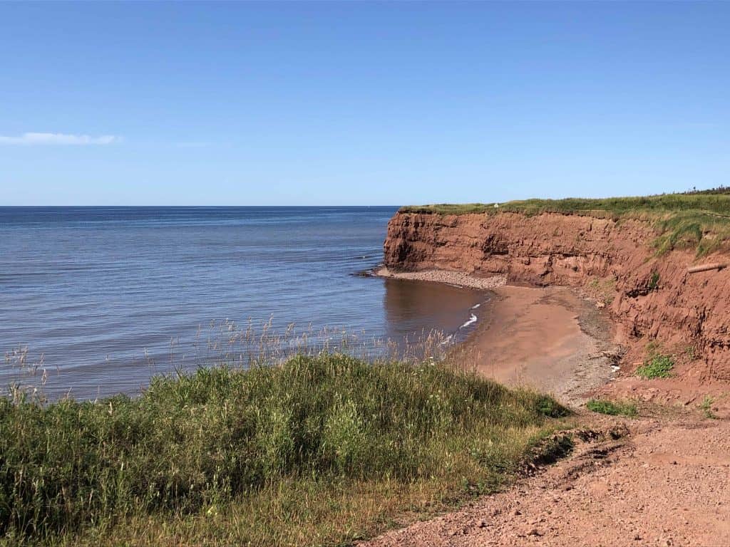 prince edward island's red cliffs and ocean.