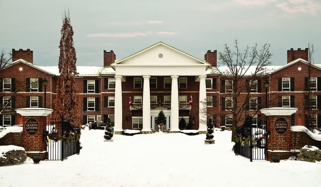 Queen's Landing hotel in Niagara-on-the-Lake, Ontario exterior in winter with snow-covered ground.