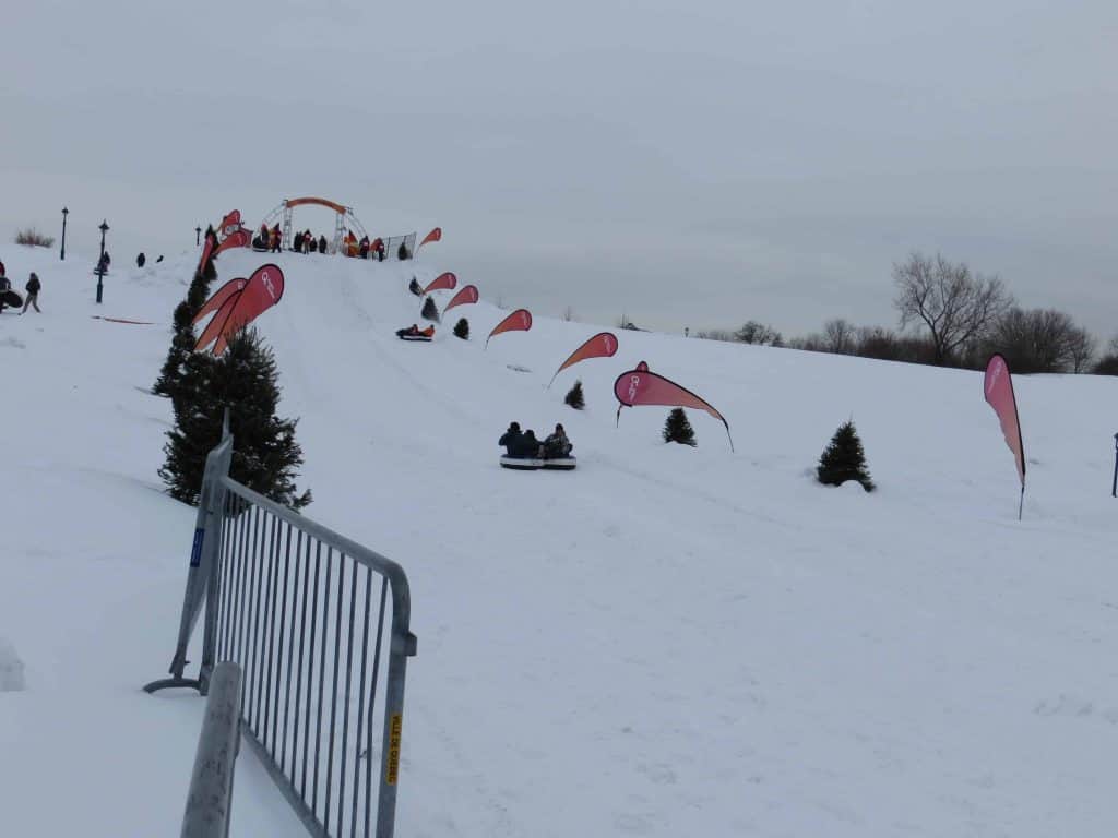 snow tubing on hill in quebec city during winter carnival.