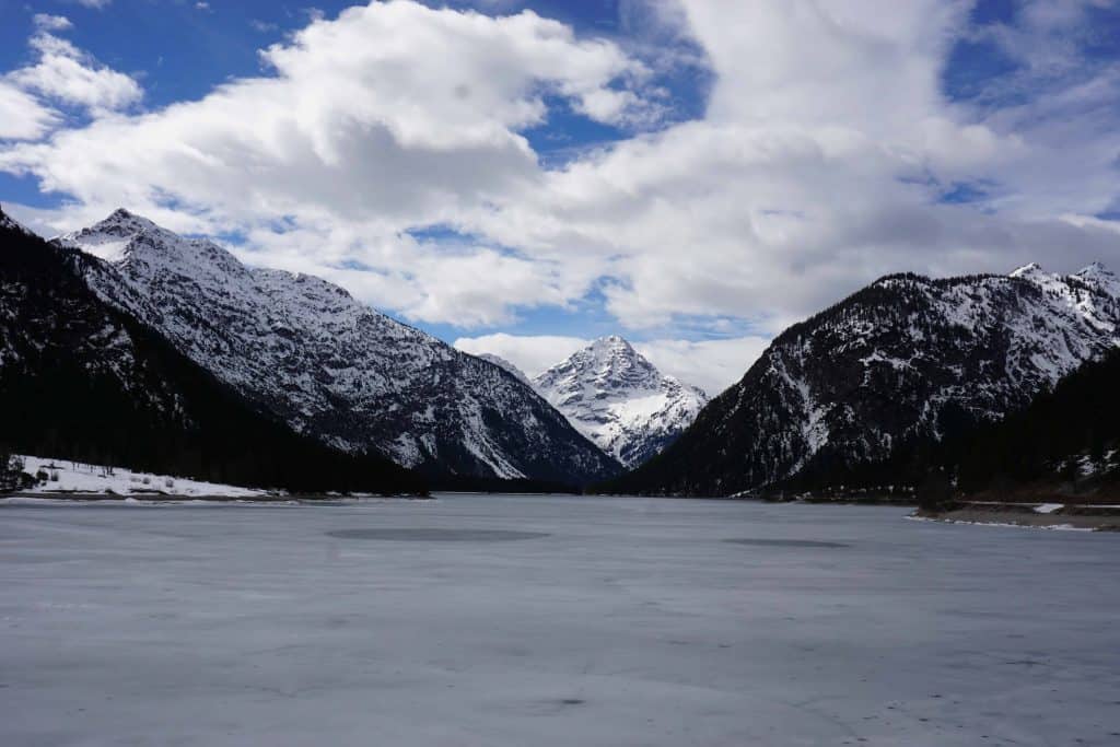 austrian alpine lake and snow topped mountains