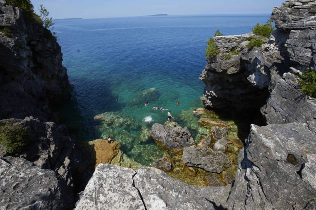 swimmers in blue grotto-bruce peninsula national park-ontario