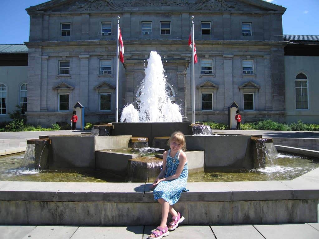 Young girl by fountain outside Rideau Hall in Ottawa, Canada.