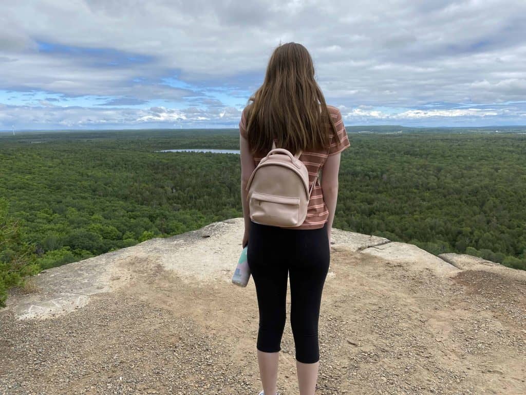 young woman enjoying view on cup and saucer trail on manitoulin island.